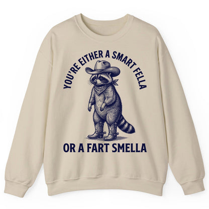 You're Either a Smart Fella or a Fart Smella cowboy raccoon Sweatshirt Sand product mockup