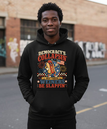 Democracy's Collapsin' but These Weiners Be Slappin' Hoodie - lifestyle model mockup - Black