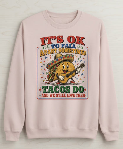 IT'S OK TO FALL APART Sometimes TACOS DO AND WE STILL LOVE Sweatshirt - product mockup - Sand