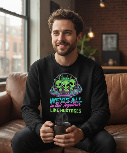 WE'RE ALL in this Together LIKE HOSTAGES Aliens Sweatshirt Black lifestyle mockup