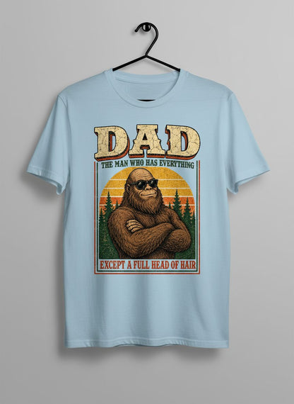 Dad the Man Who Has Everything Except a Full Head of Hair Funny Bigfoot T-Shirt - product mockup - Light Blue