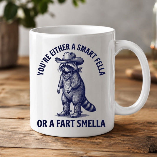 You're Either a Smart Fella or a Fart Smella cowboy raccoon White Mug White product mockup