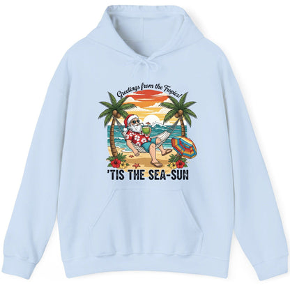 Greetings from the Tropics 'Tis the Sea-Sun santa claus on a tropical vacation Hoodie Light Blue product mockup