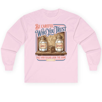 Be Careful Who You Trust Salt and Sugar Look the Same Long Sleeve Tee - product mockup - Light Pink